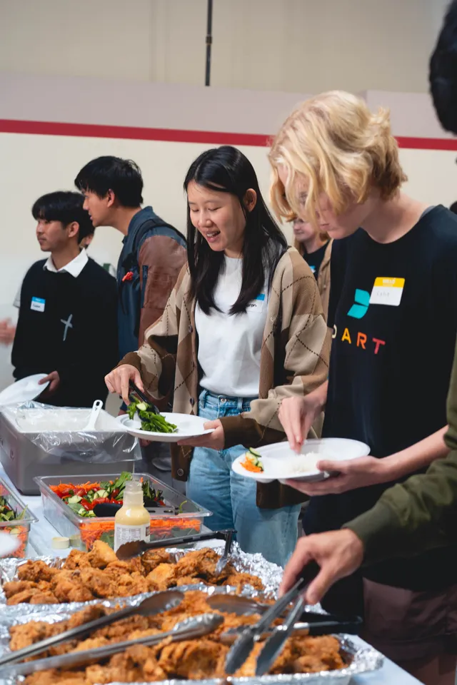 Students serving themselves a meal together after service