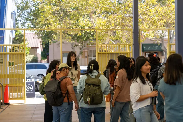 Students walking in together through the entrance gate