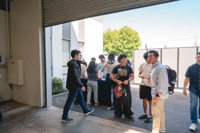 Students walking in together through the entrance gate