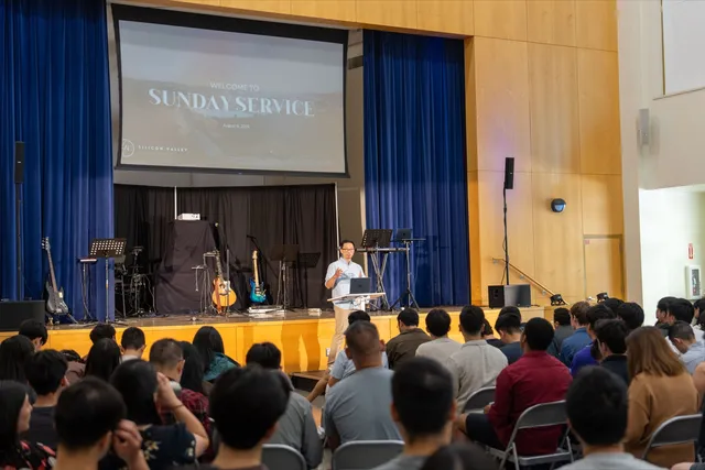 Pastor teaching from the stage during Sunday service