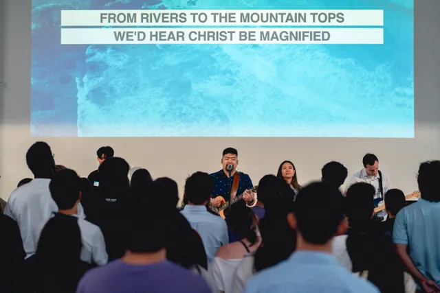 Congregation singing along with worship lyrics on screen